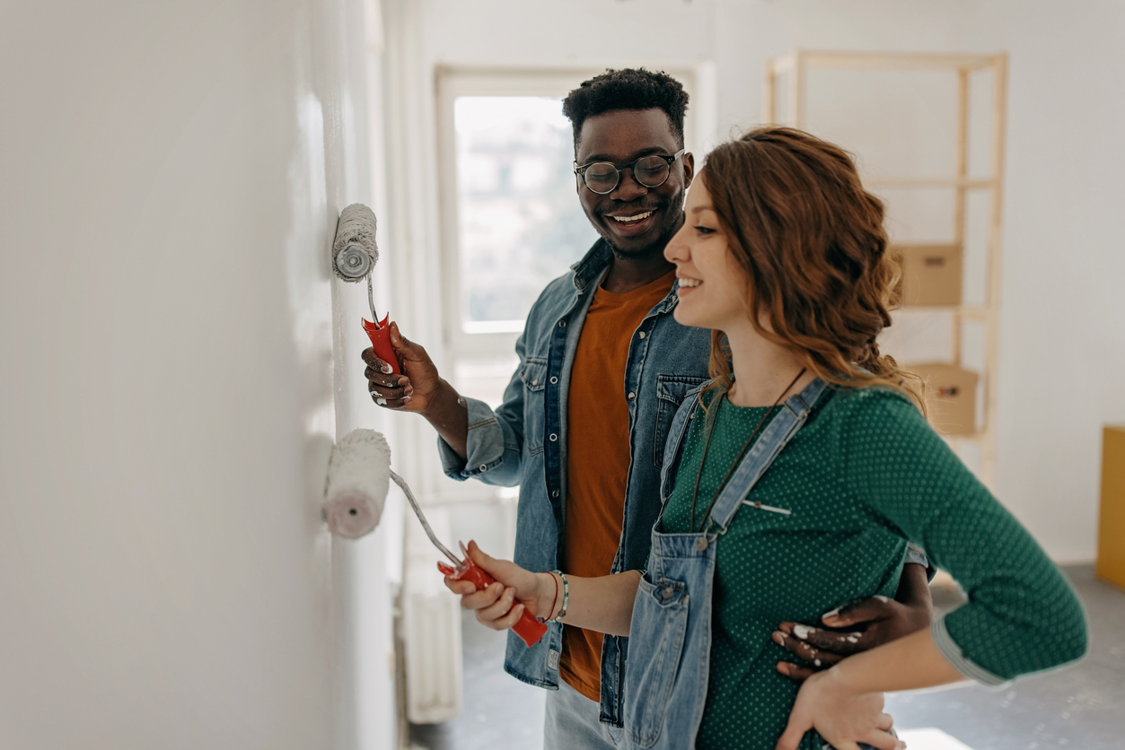 Young couple painting walls